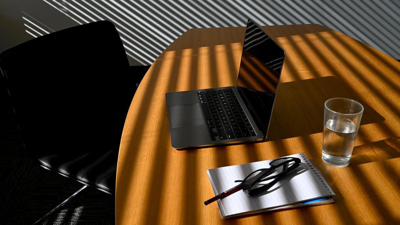 A laptop is seen on a work desk