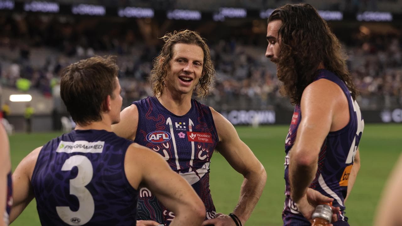 Nat Fyfe and captain Alex Pearce with Caleb Sarong.