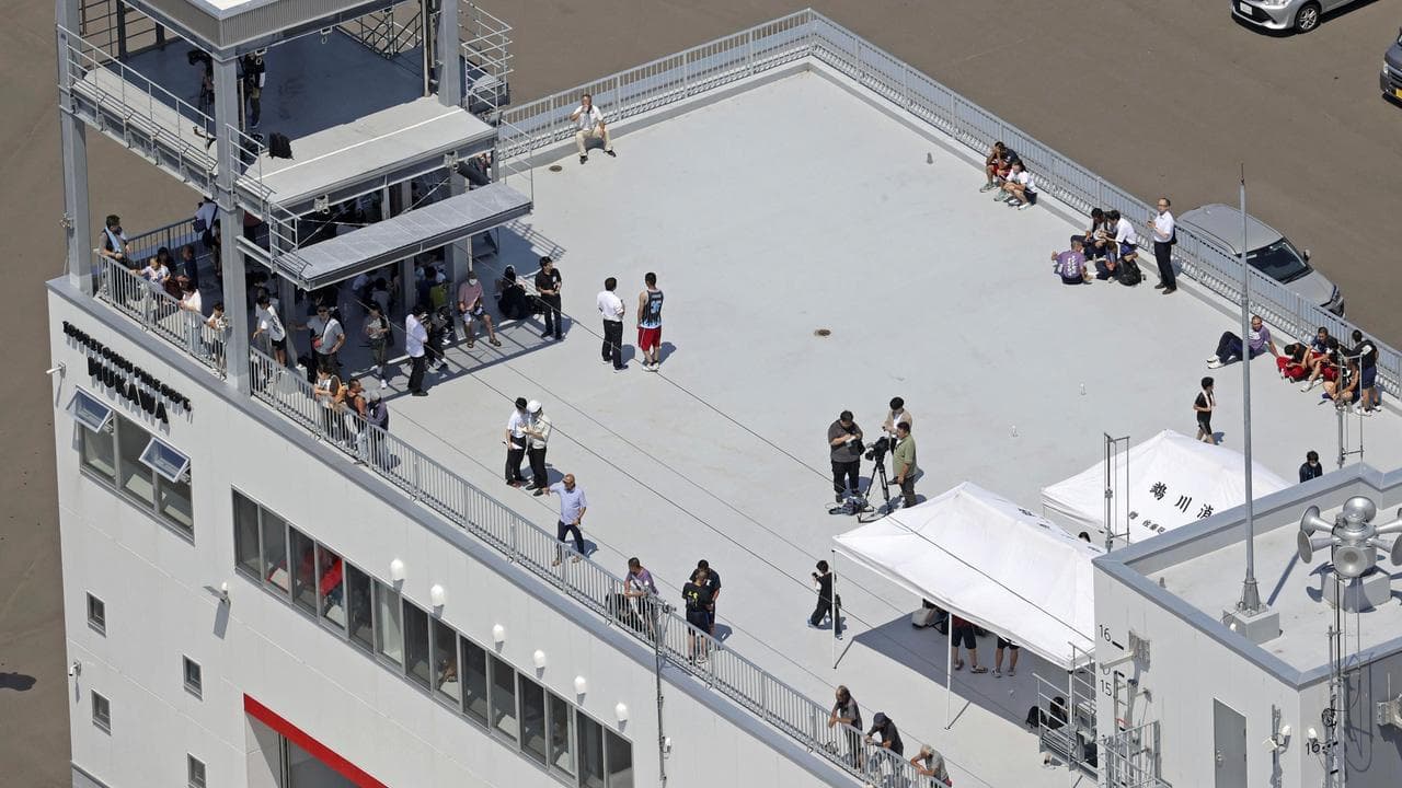 People shelter on the roof of a fire station in Mukawa town, Hokkaido