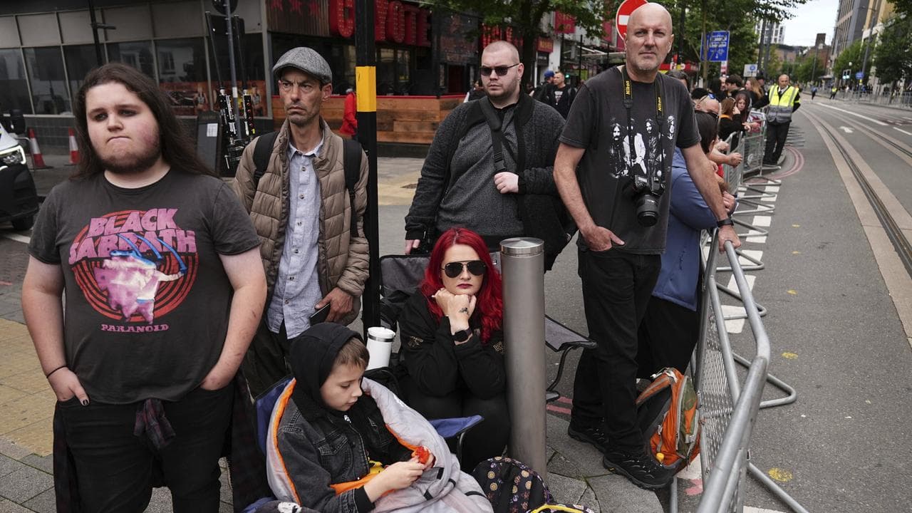 Fans gather near the Black Sabbath Bridge bench in Birmingham