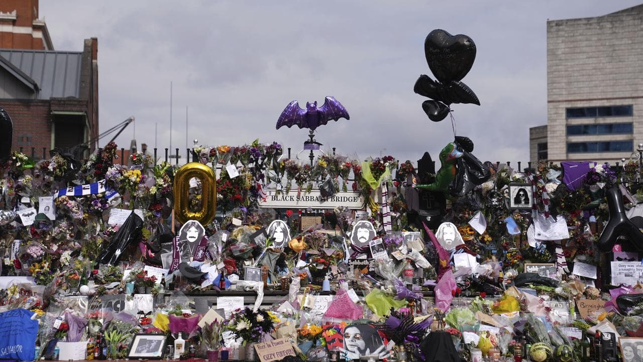 Floral tributes left at the Black Sabbath Bridge bench on Broad Street