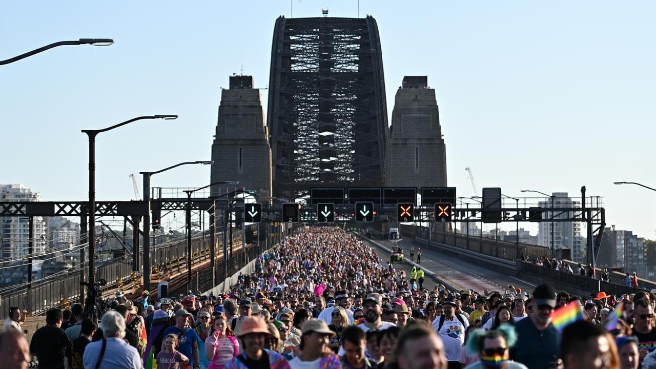 A WorldPride march across the bridge in 2023
