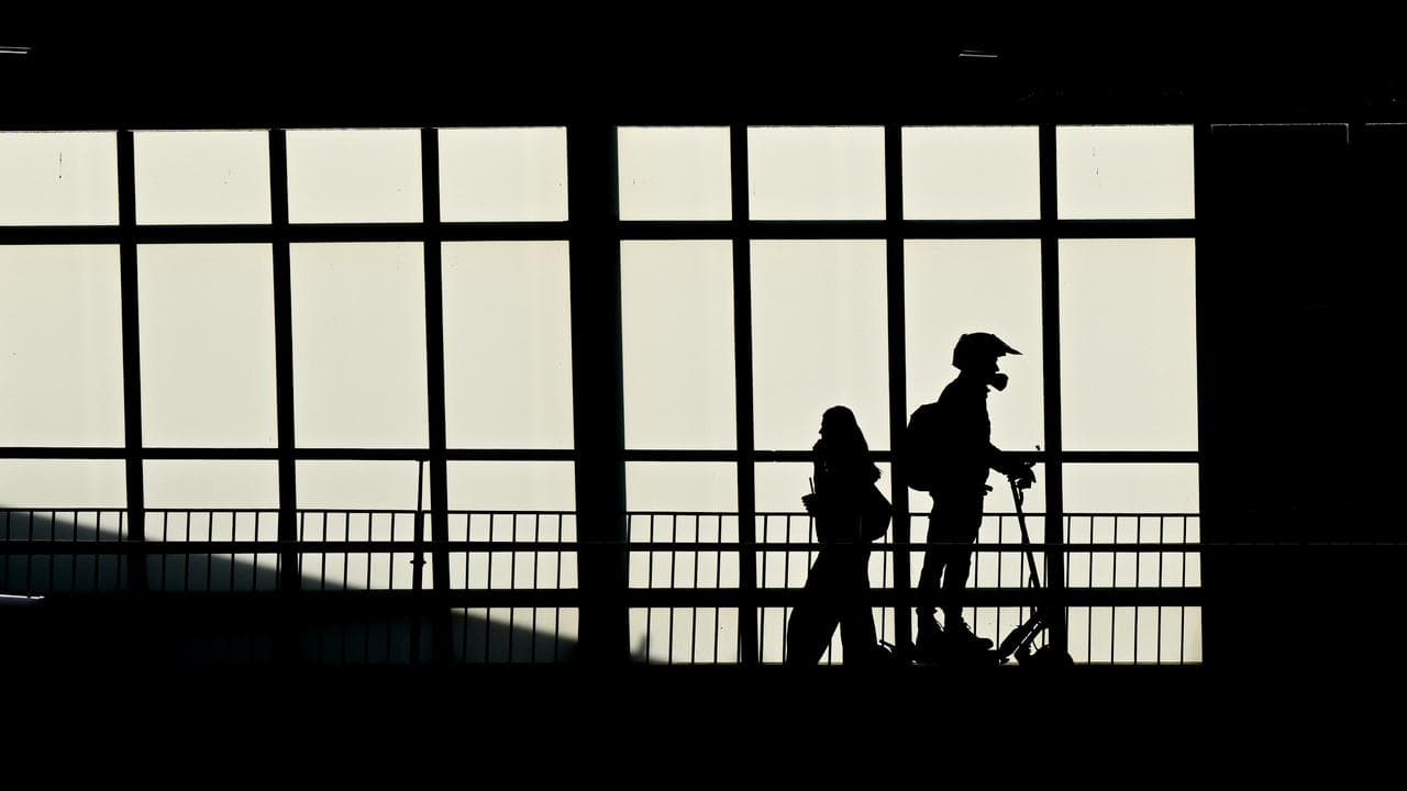 A pedestrian and a person riding an electric scooter