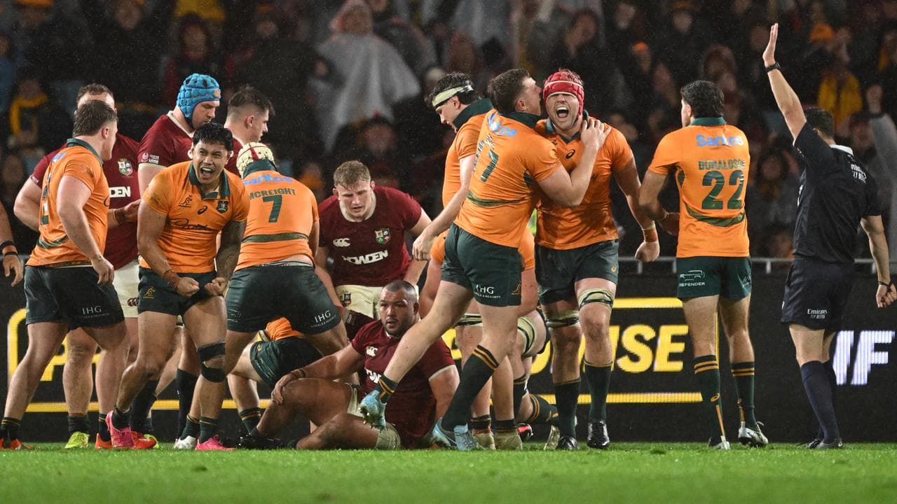 Australian players celebrate their victory over the Lions