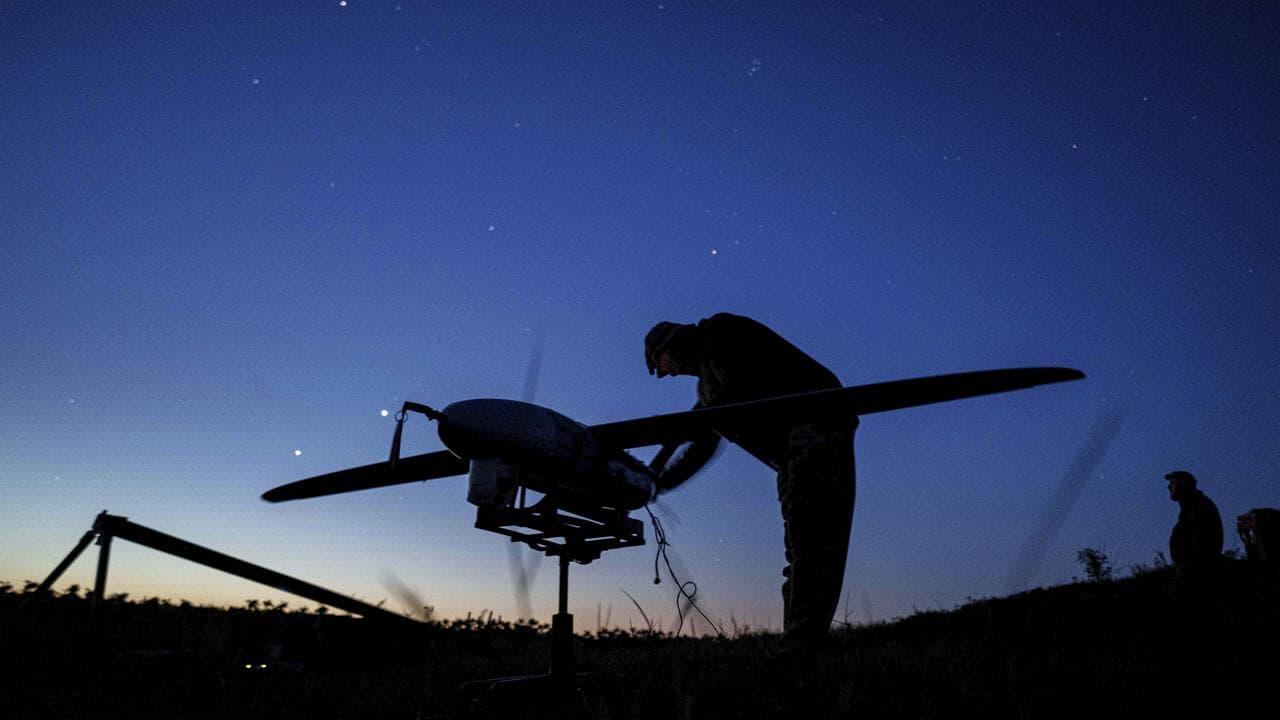 A Ukrainian soldier prepares a drone