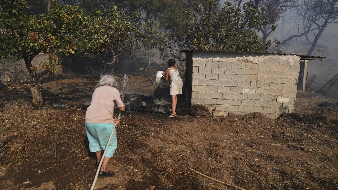 People fight a fire near their property