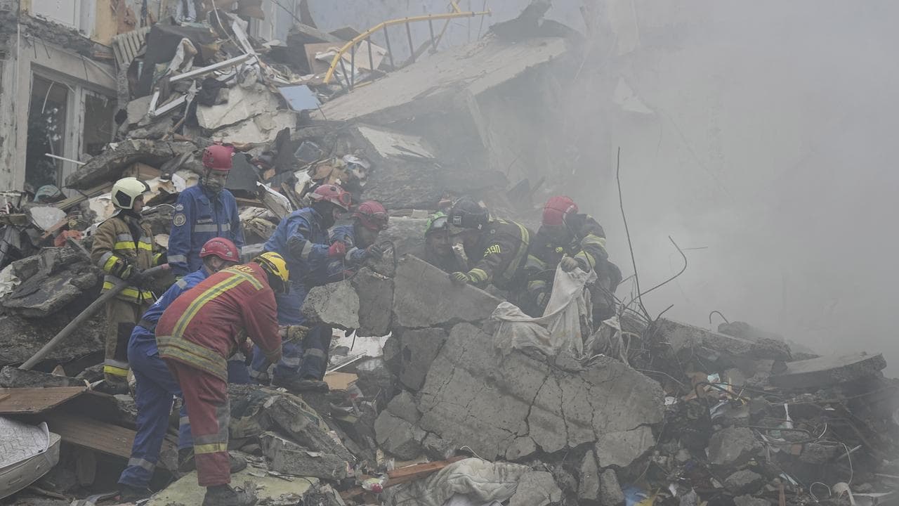 Rescuers work in a destroyed apartment building in Kyiv (file image)