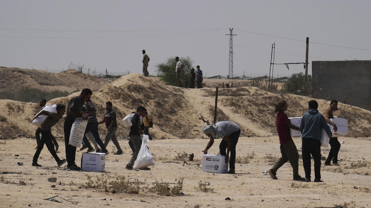 Palestinians collect humanitarian aid packages