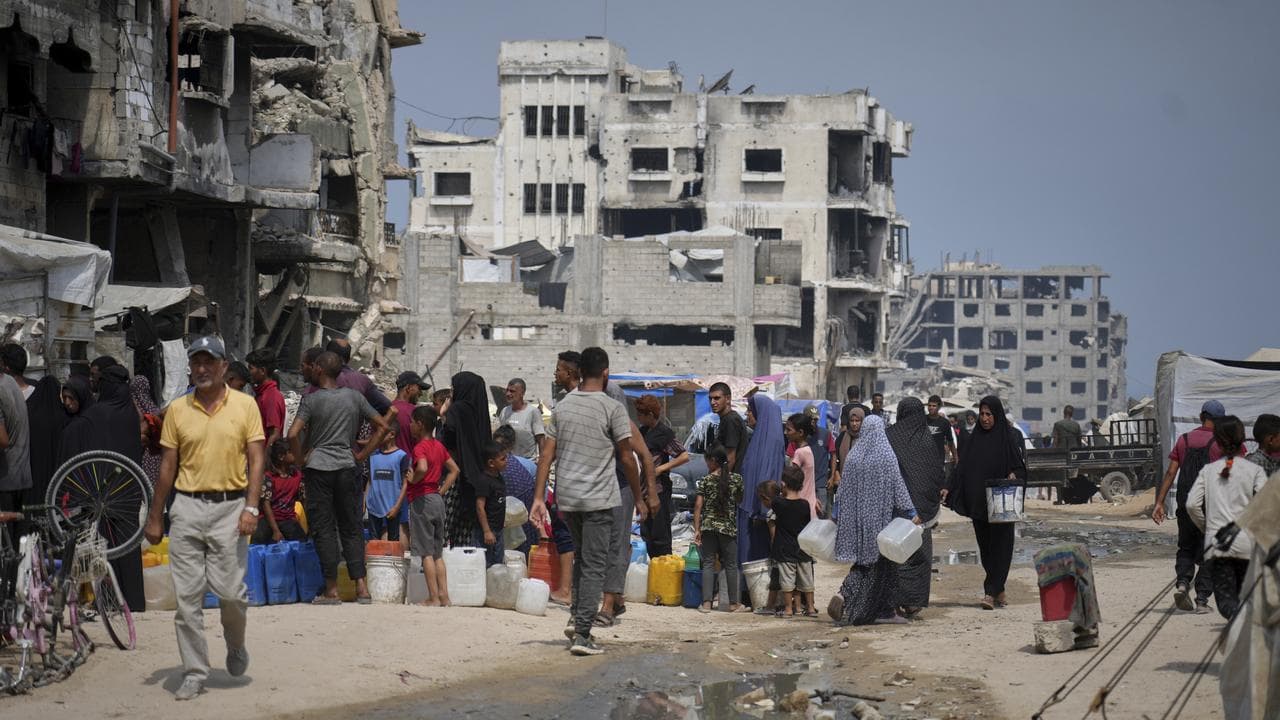 Palestinians collect water from a distribution point in Gaza City
