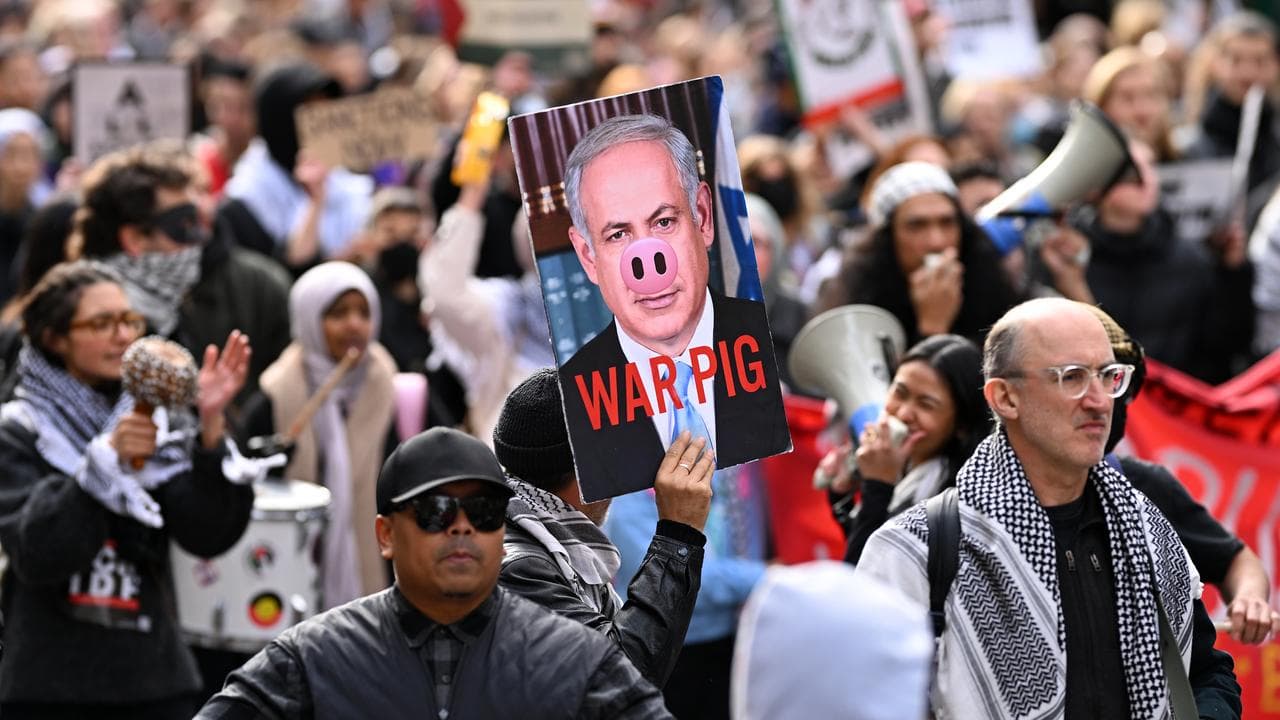 A protester holds up a placard of Benjamin Netanyahu (file image)