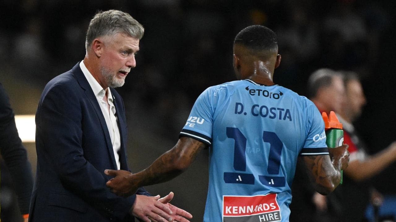 Douglas Costa of Sydney FC speaks with coach Ufuk