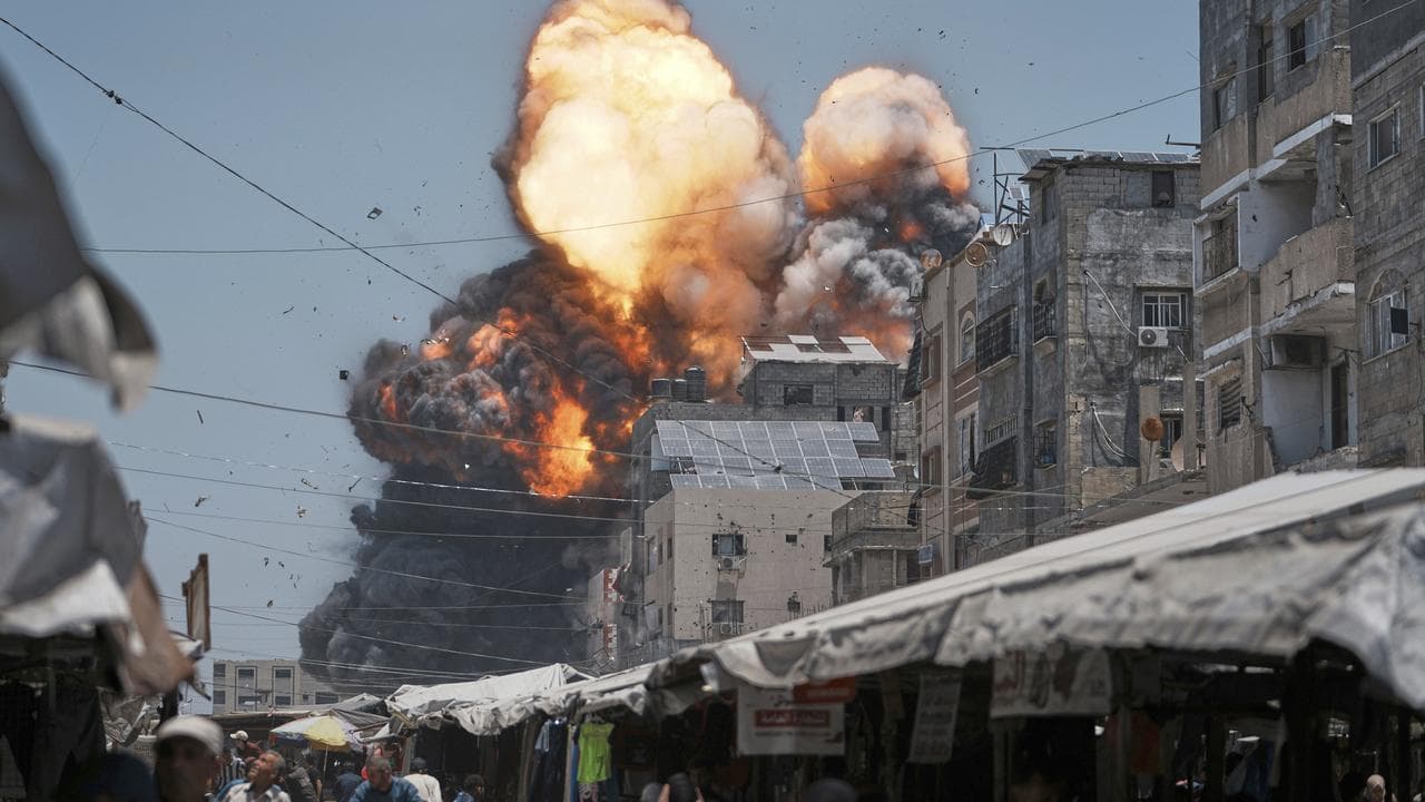 Thick smoke and flames erupt from an Israeli airstrike in Gaza City
