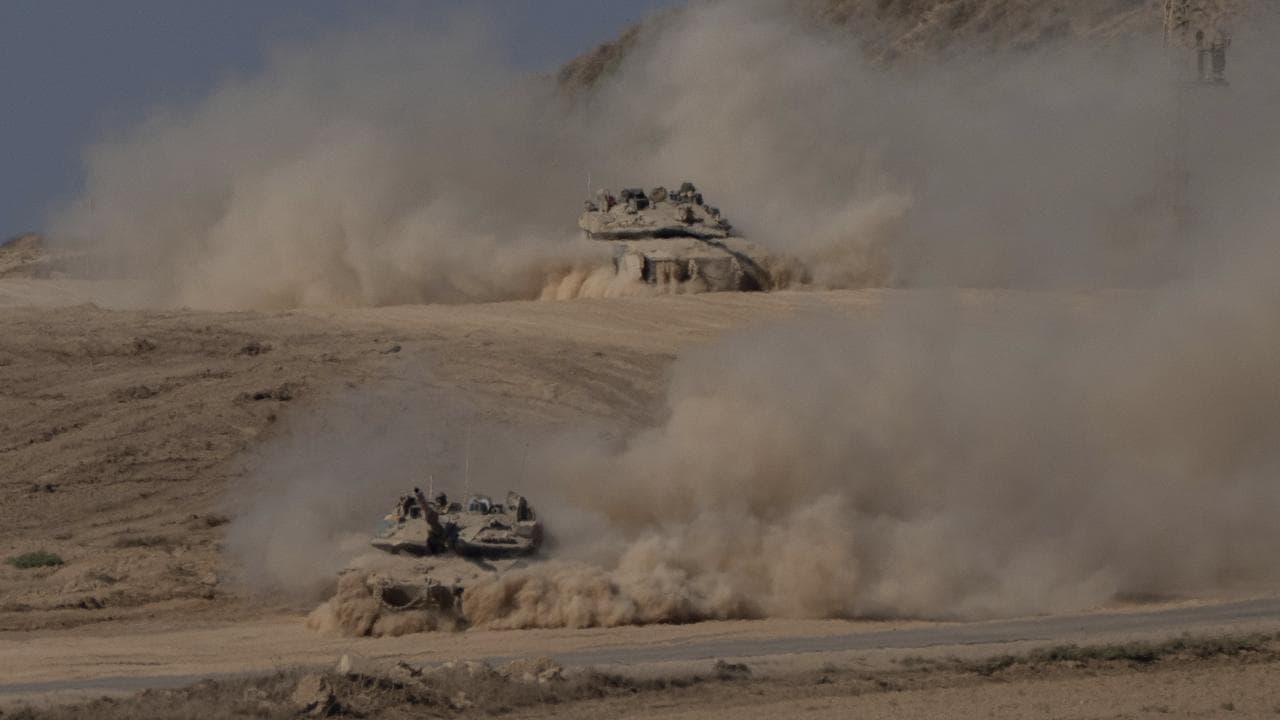 Israeli tanks move through an area near the Israeli-Gaza border