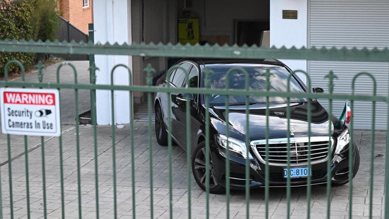 An official car leaves Iran's embassy in Canberra