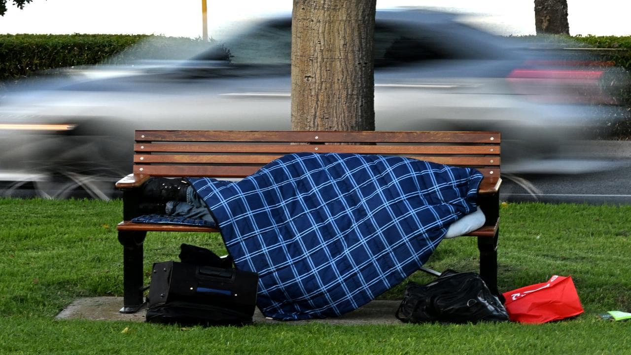 A homeless person sleeping on a park bench (file image)