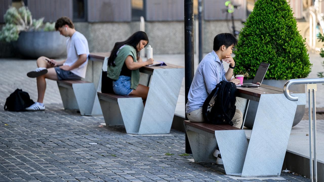 Students are seen working on digital devices