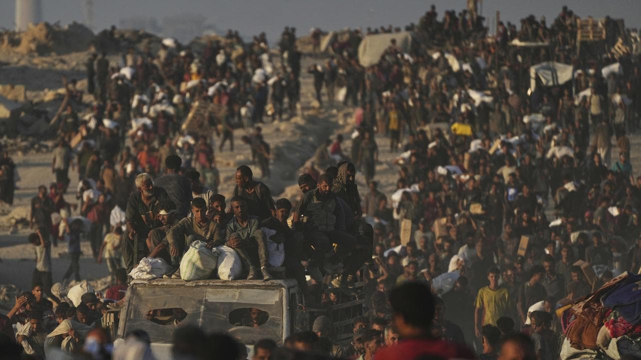 Palestinians carry food in Gaza