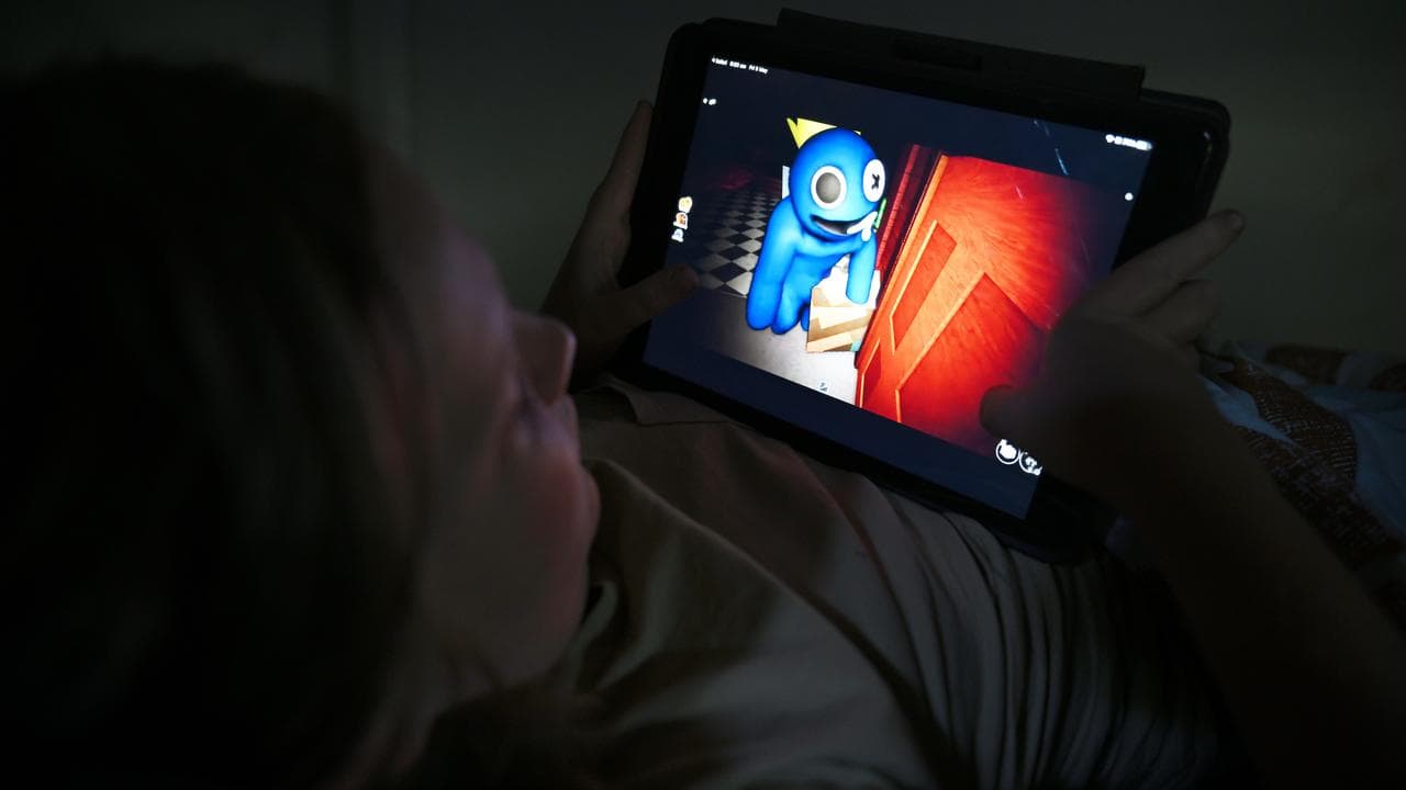 A young child plays the Rainbow Friends Roblox game