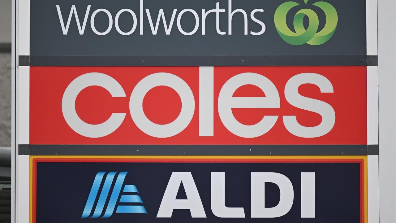 Signs and logos of Woolworths, Coles and Aldi (flle image)