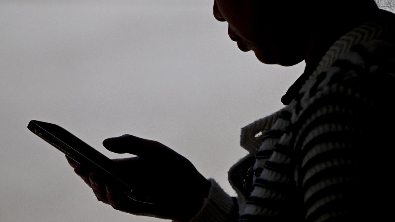 A person using a mobile phone (file image)