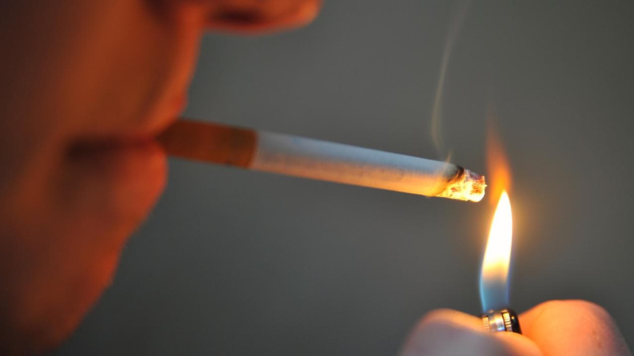 Person lights a cigarette