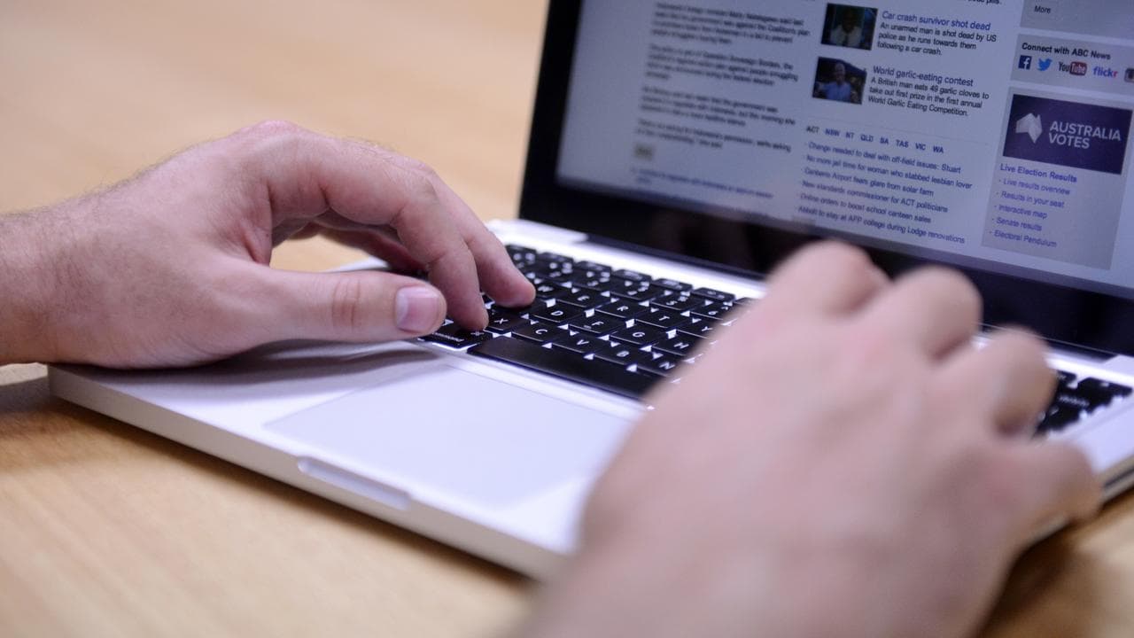 A man uses a laptop computer in Brisbane
