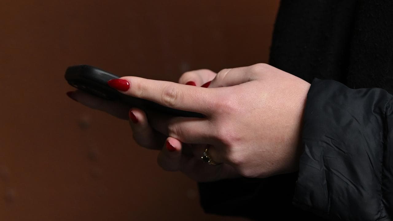 A stock photo of a person holding a phone