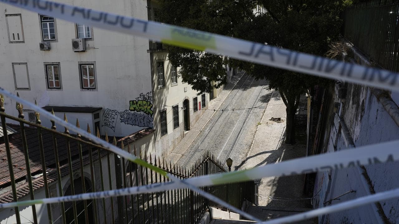 Police tape cordons off the access to tracks of the Gloria funicular