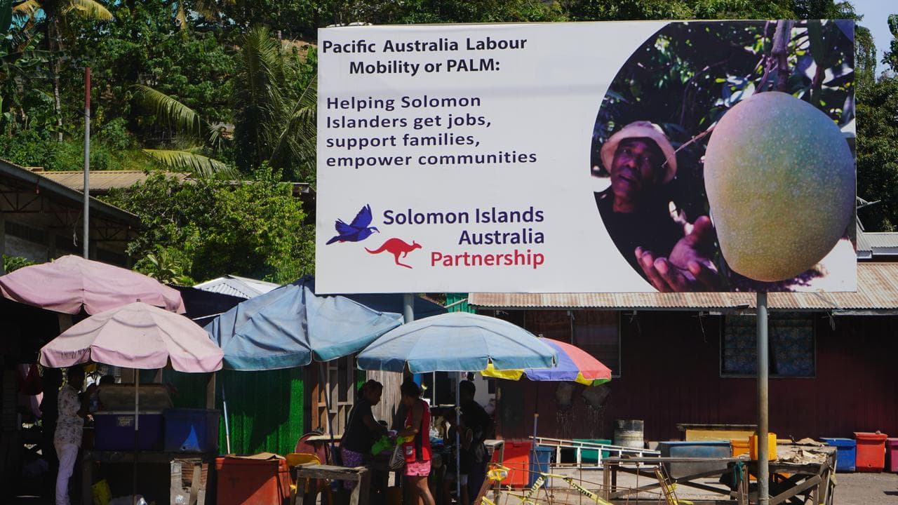 Sign promoting the Pacific Australia Labour Mobility scheme in Honiara