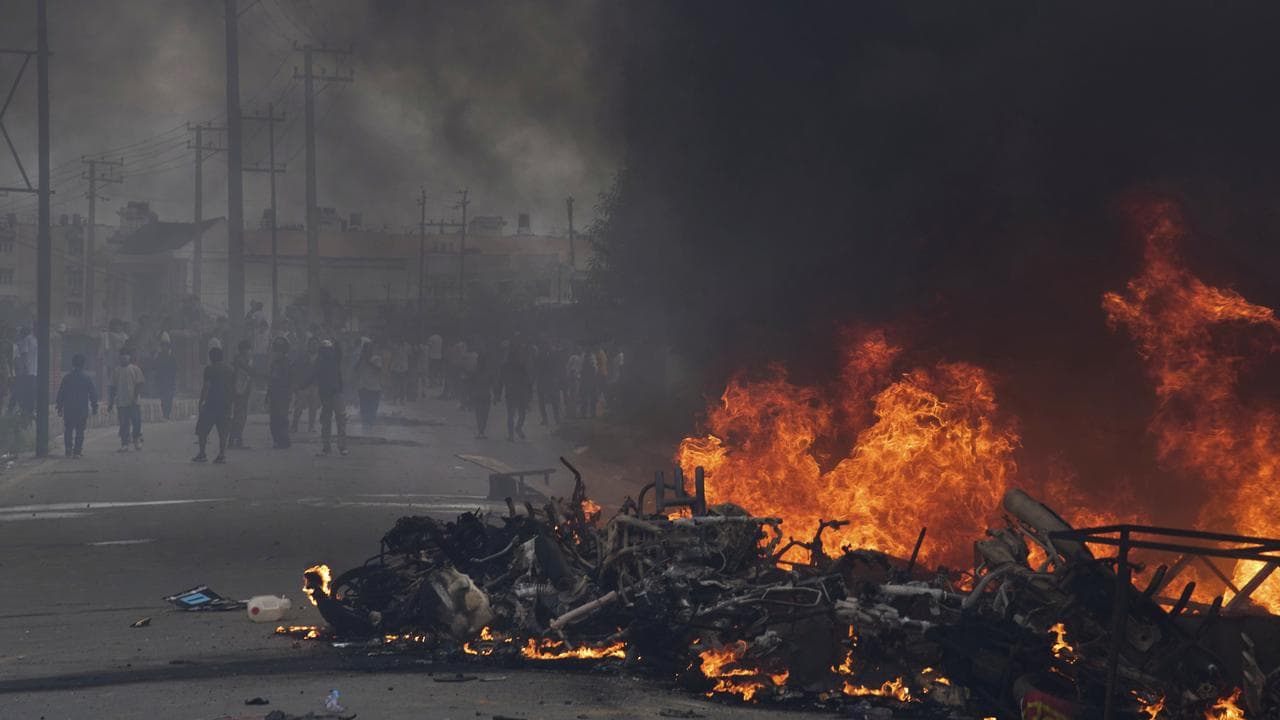 Protesters burn vehicles and tyres during a protest in Kathmandu, Nepa