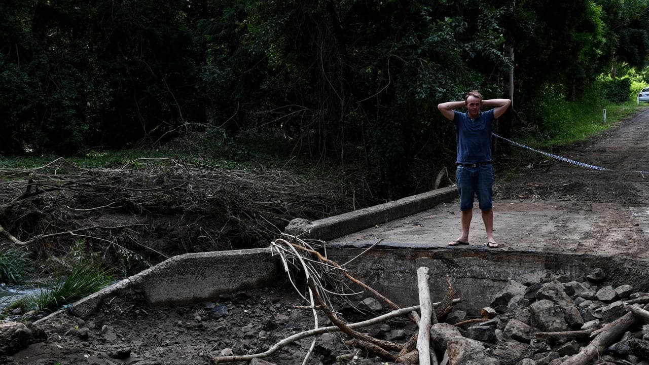 A man on a washed-out road near Nimbin, NSW