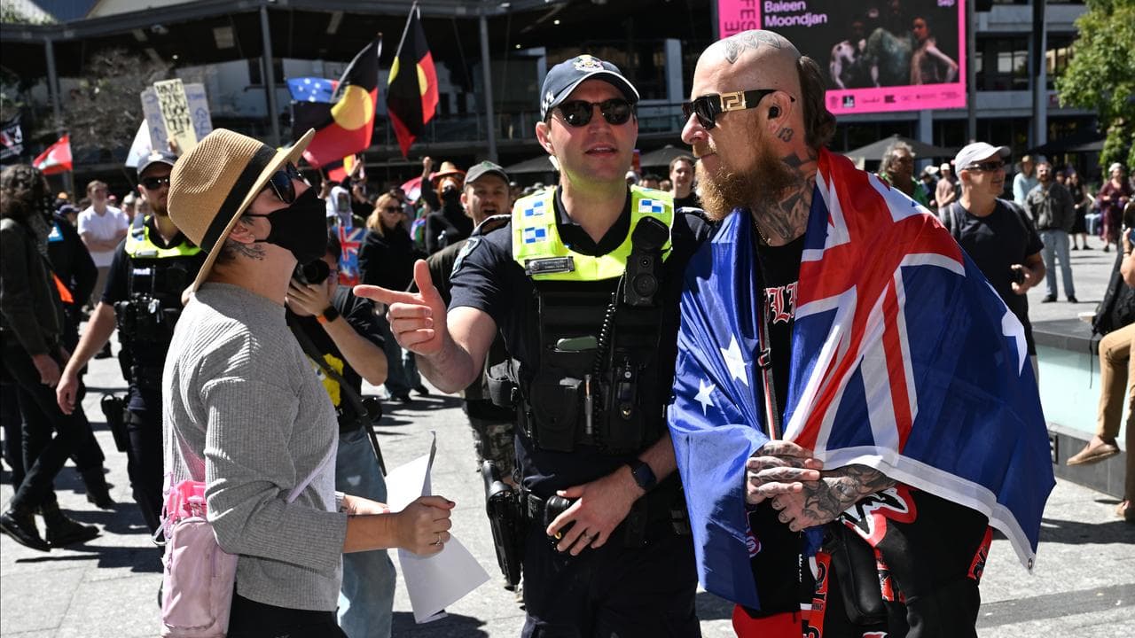 Police are seen separating differing protest groups during a rally