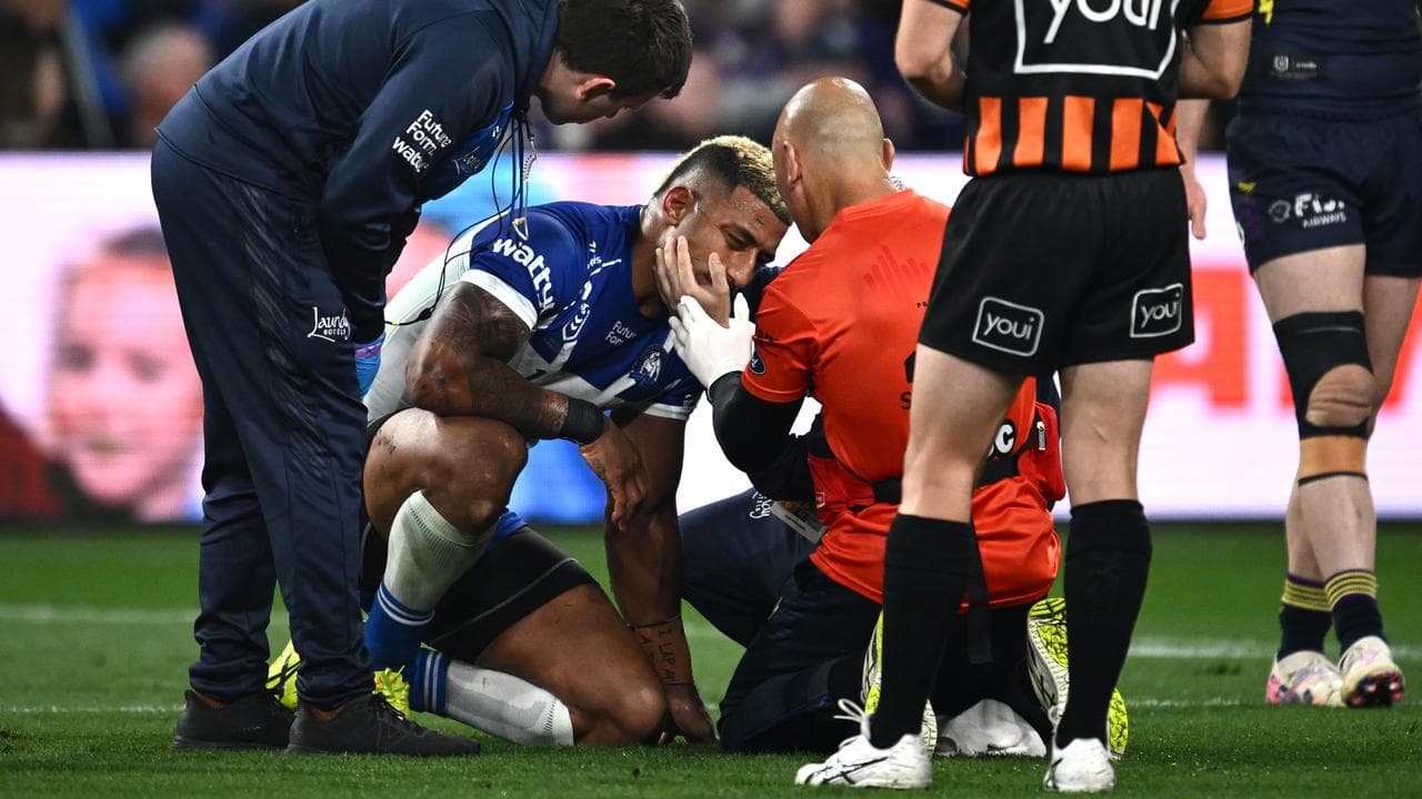 Canterbury's Viliame Kikau is checked out by a trainer.
