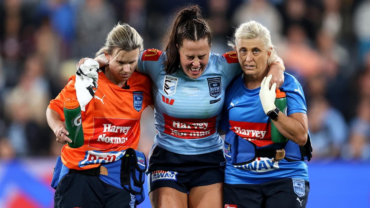 An injured Isabelle Kelly leaves the field.