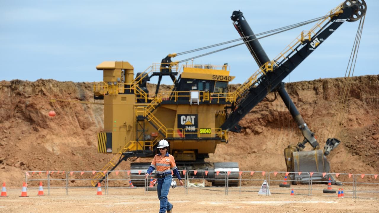 Shovel operator Sarah Engel walks away from her machine