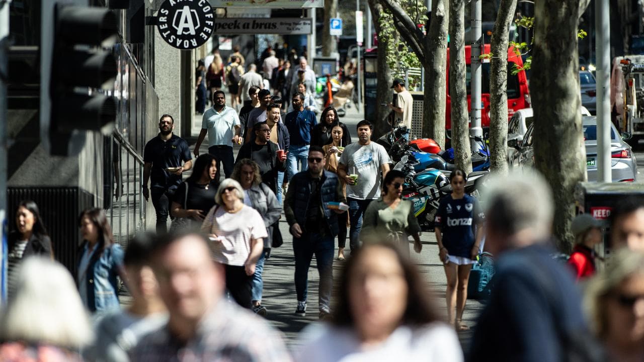 Office workers are seen in the Central Business District in Melbourne