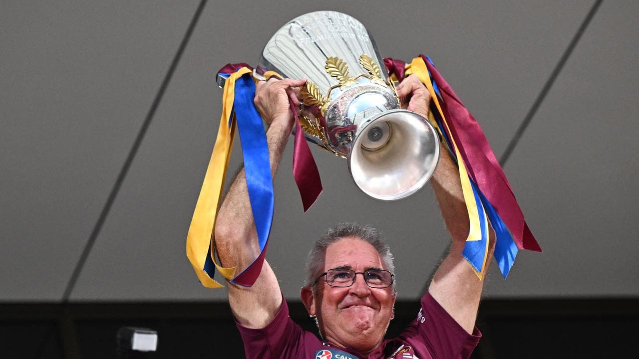 A proud Chris Fagan raises the 2024 premiership trophy.