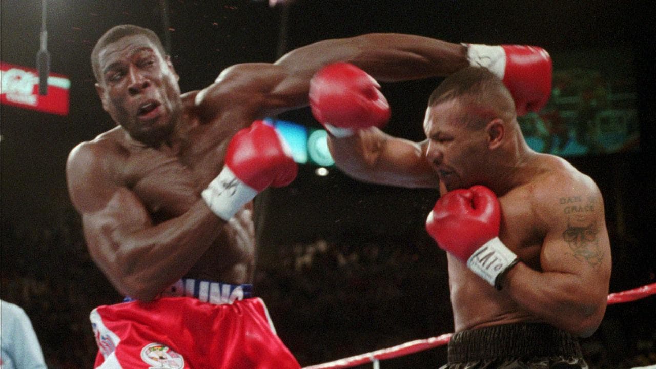 Mike Tyson (right) connects with a punch to Frank Bruno