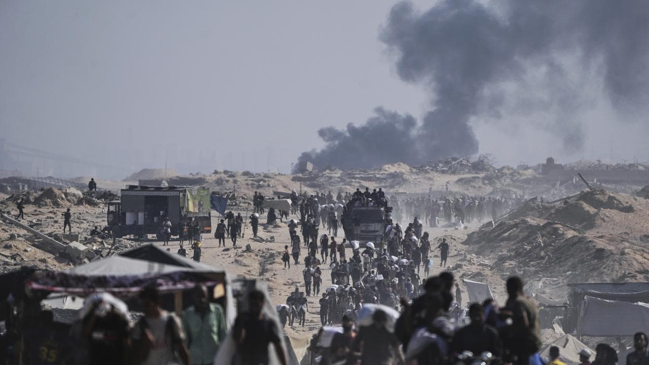 Palestinians carry sacks of flour from an aid convoy in northern Gaza