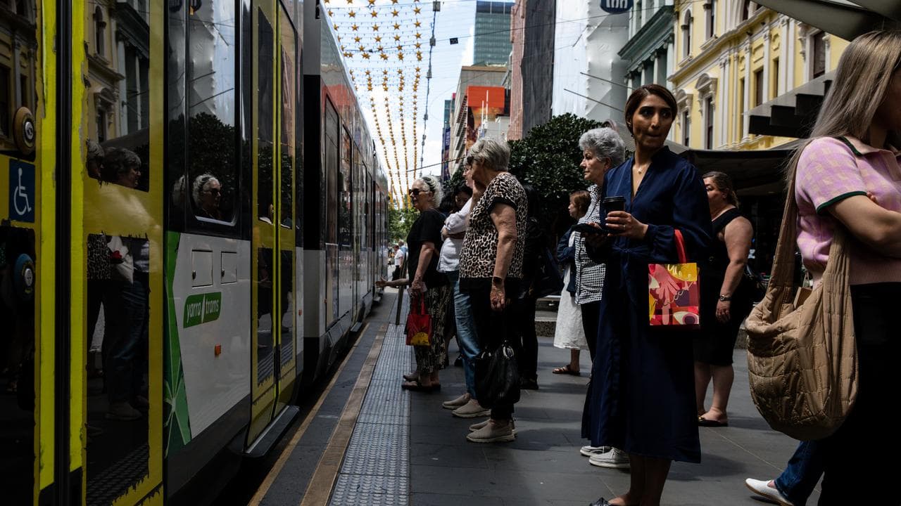 People wait at a tram stop in Bourke Street Mall (file image)