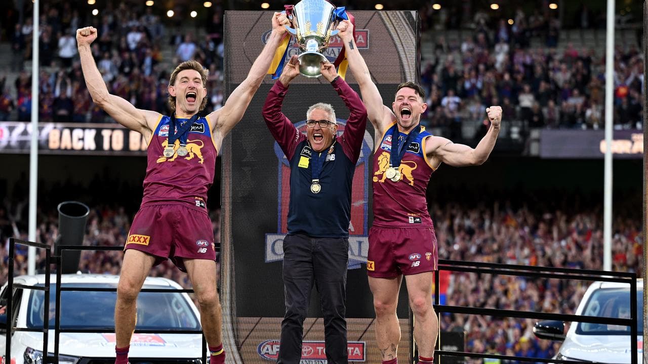 Chris Fagan (centre), with Harris Andrews and Lachie Neale.