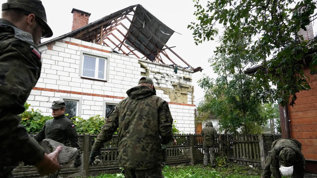 Officers at a damaged house after drone incidents in Poland