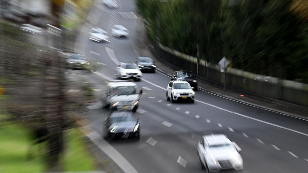 Passenger vehicles travel along a motorway