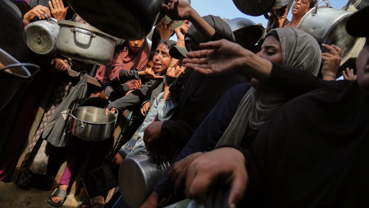 Palestinians at a community kitchen in Khan Younis, southern Gaza