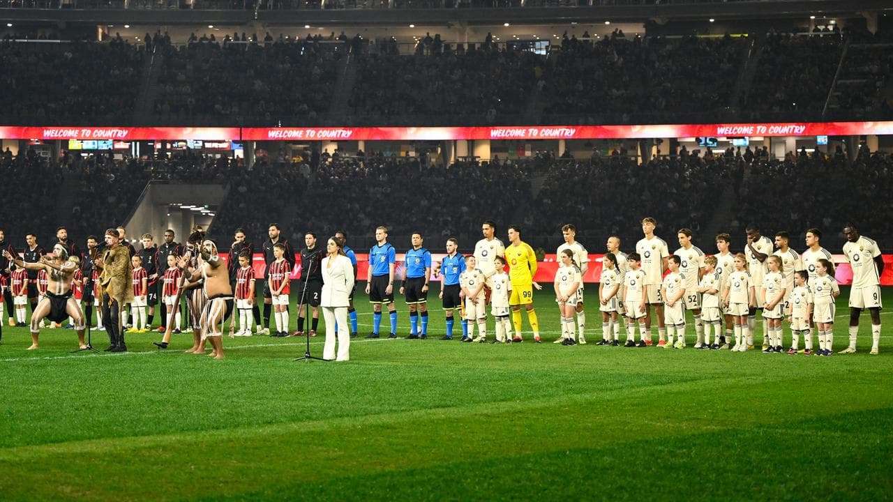 AC Milan and Roma teams line up.