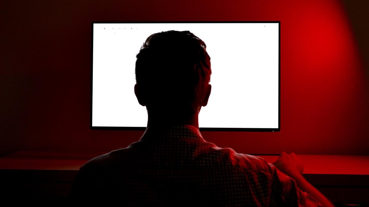 Man looks at computer screen