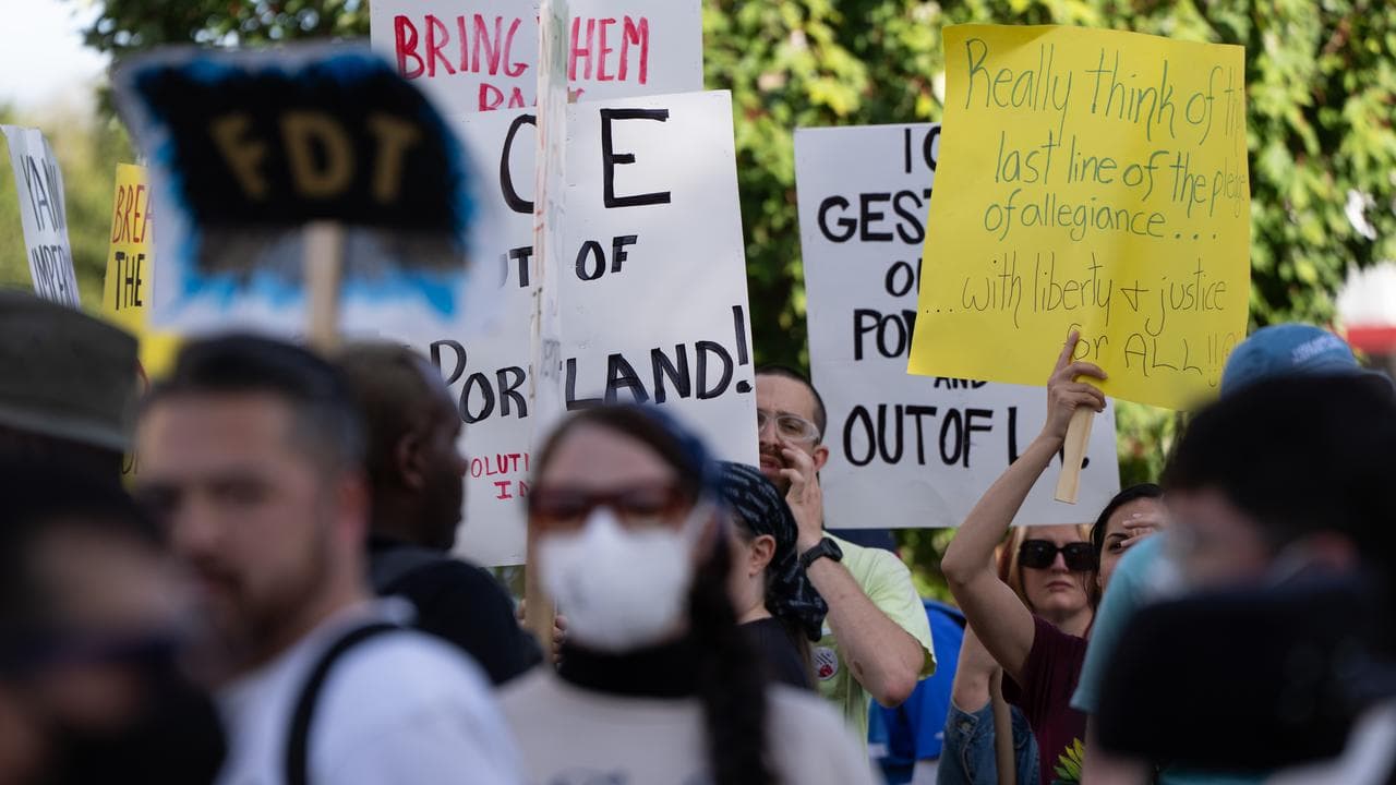 People protest outside an ICE facility in Portland, Oregon