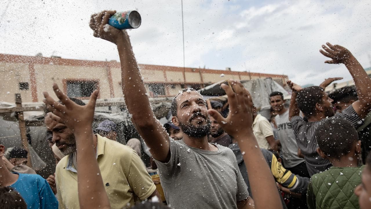 Palestinians celebrate a ceasefire agreement in Khan Younis, Gaza