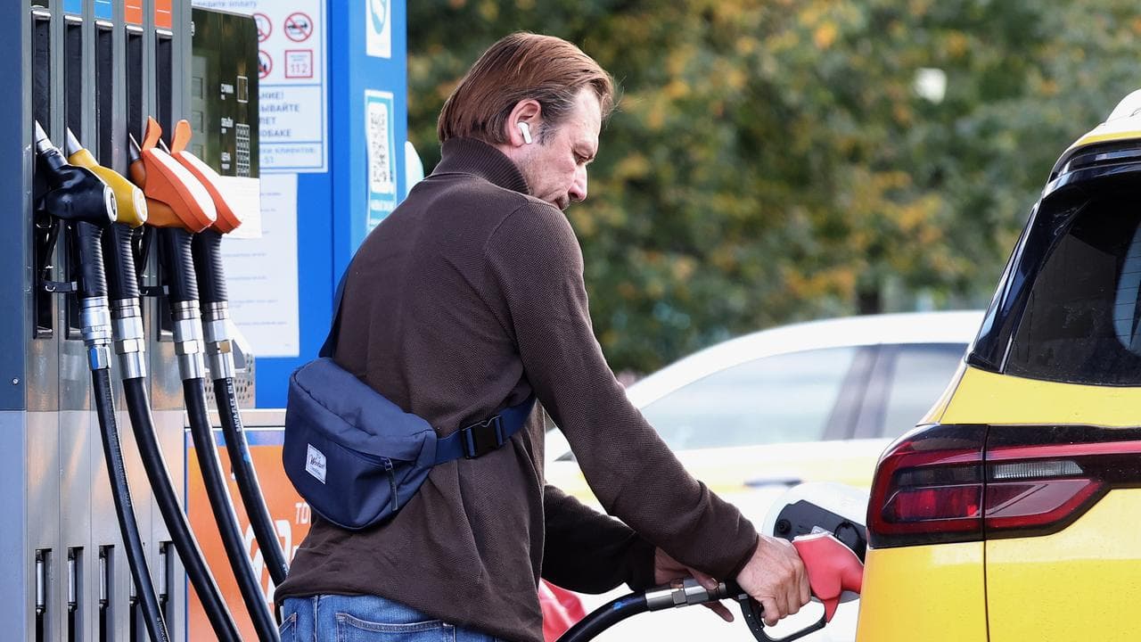 A man fills a car at a gas station in Moscow, Russia