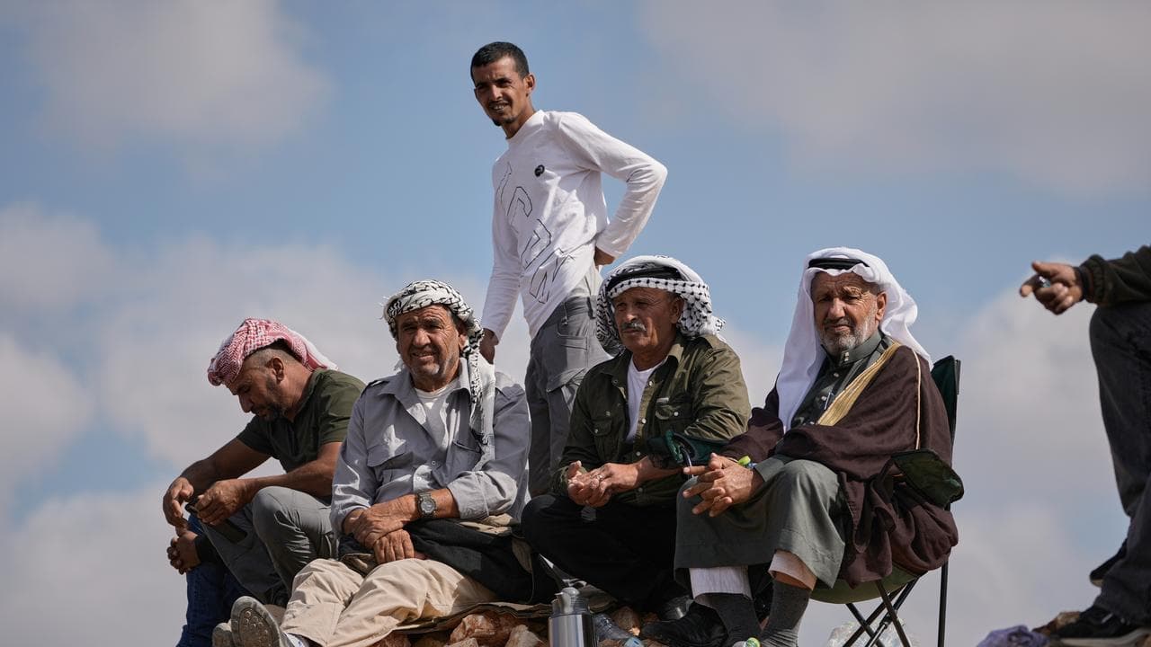 Palestinians look toward the Israeli Ofer Prison in the West Bank